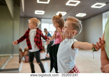 Modern Dancers. Group Of Fashionable Children Learning A Modern Dance While Having A Choreography Cl