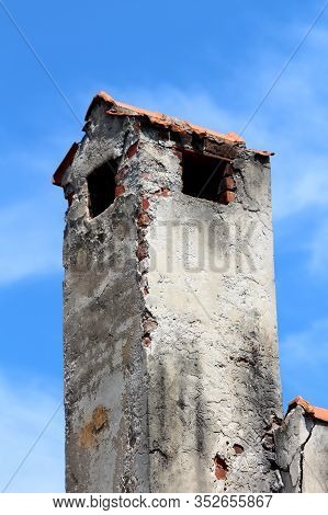 Large Old Dilapidated Chimney With Single Opening On Each Side And Cracked Dirty Facade Mounted On S