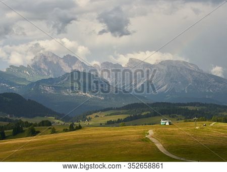 Sassolungo Mountains On The Italian Alps Dolomites And A Rainbow