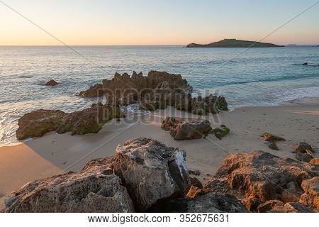 Porto Covo Beach At Sunset With Ilha Do Pessegueiro Island On The Background, In Portugal