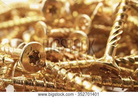 Torx Screws Close Up. Gold Screws For Wood, Chipboard Or Plywood With Torx Head.