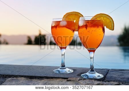 Two Glasses With Spritz Veneziano, An Italian Cocktail Drink From Aperol, Prosecco And Soda On A Wal