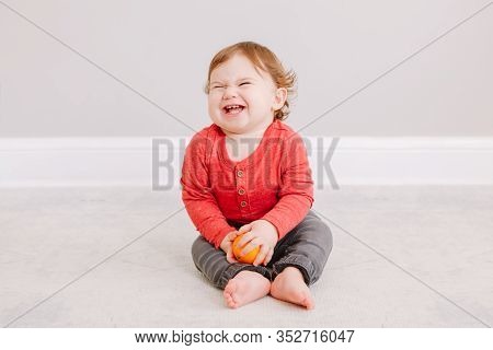 Cute Adorable Caucasian Baby Boy Eating Citrus Fruit. Finny Child Eating Healthy Organic Snack. Soli