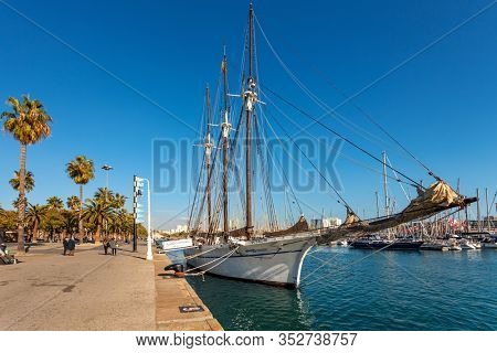BARCELONA, SPAIN - JANUARY 13, 2015: Promenade and Santa Eulalia - three-masted schooner built in 1918 under the name Carmen Flores. It was bought and renamed by Maritime Museum of Barcelona in 1997.