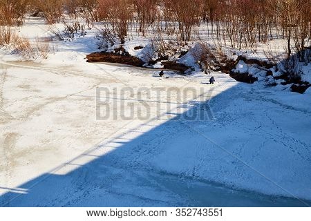 Kirov, Russia - March 23, 2019: Fisherman On The Ice Of The River On A Sunny Spring Day. Top View Of