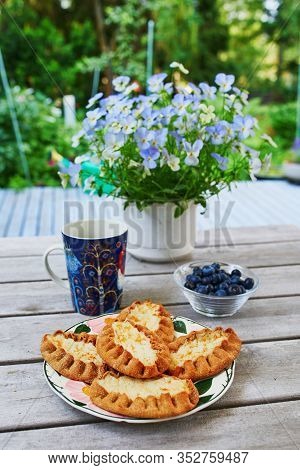 Karelian Pies (karjalanpiirakka) Made Of Thin Rye Flour With A Filling Of Rice Served With Blueberri