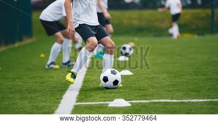 Sports Soccer Players On Training. Boys Kicking Soccer Ball On Practice Session. Kids Playing Soccer