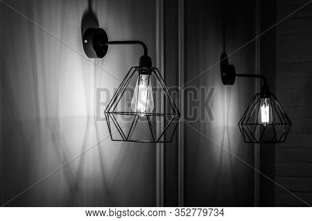 Black And White Stock Photo Of Modern Pendant Light In Diamond Shape Wire Lampshade With Light Bulb 