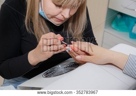 Manicuring Nails - Application Of Base Coat. Selective Focus, High Key