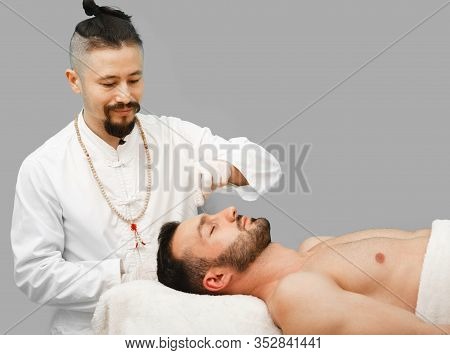 Man Enjoys The Acupuncture Procedure. Acupuncturist Doing Acupuncture Very Accurately