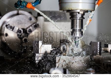 A Process Of Vertical Cnc Steel Milling With External Water Coolant Streams, Splashes And A Lot Of M