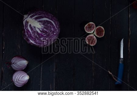 Sliced Vegetables And Fruits. Vegetables And Fruits Are Blue. Knife With A Blue Handle.