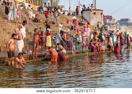 Varanasi, India - March 18, 2019: People Bathing In Water Holy Ganga River At Kedar Ghat In Morning