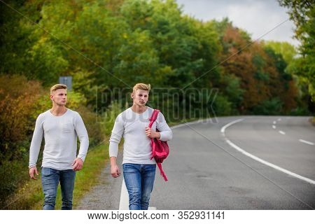 Adventure Concept. Guys Hitchhiking On Road. Tourist Traveler Travel Auto Stop. Transporting Issues.