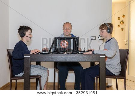 Man Works From Home And Children And Teens Studying At Home With Pc Because Of The Coronavirus.