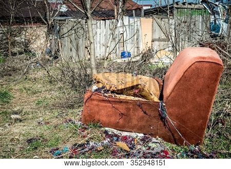 Worn, Dirty And Broken Armchair Abandoned. 21st Century In Bucharest, Romania.