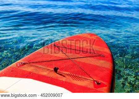 Red Supboard On Peace And Quiet Water Sea Outdoors Sunny Day