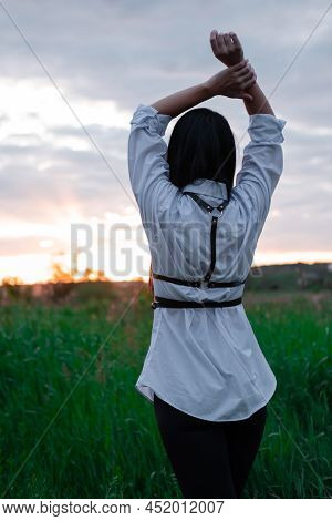 Brunette Woman In White Blouse With Baldric On Summer Field On Sunset. Peaceful Time. Millennial Gen