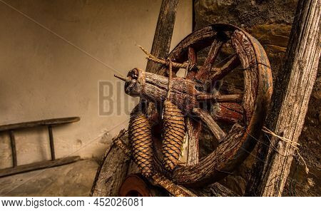 A Rustic Wooden Wheel With Pine Tree Cones In Poffabro, An Historic Medieval Village In The Val Colv
