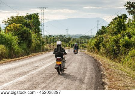 Motorcycle Travels On The National Highway T 16 From Salavan To Pakse, Laos. Asphalt Road On Bolaven