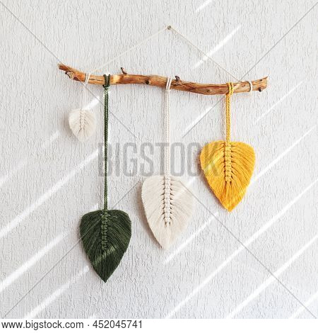 Macrame Leaves Wall Hanging In Yellow, White And Green  And Natural Color On The Wooden Stick. Cotto