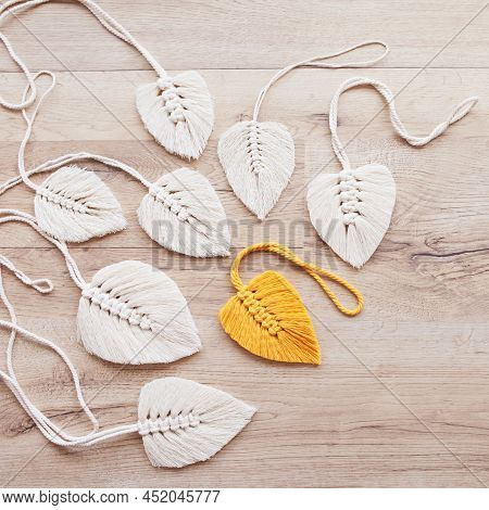 Macrame Leaves In Yellow  And Natural Color On The Wooden Background. Cotton Rope Decor Macrame To M
