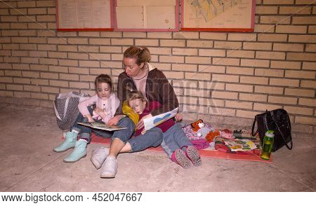 A Mother With Her Young Children While They Are Preparing For An Attack By A Russian Aggressor In A