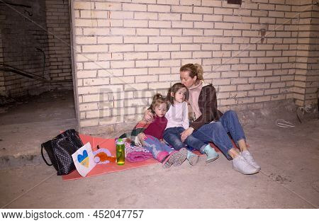 A Mother With Her Young Children While They Are Preparing For An Attack By A Russian Aggressor In A