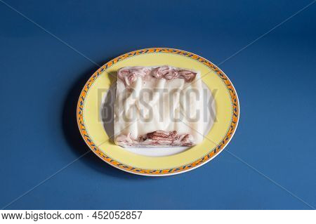 Deep-frozen Clean Squid In The Shape Of A Square On A Decorative Plate And Blue Studio Background. F