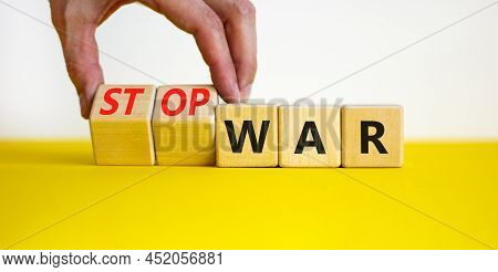 Stop War Symbol. Businessman Turns Cubes And Changes Concept Words War To Stop War. Beautiful Yellow