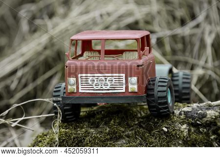 An Old Thrown Away Car, Toy Car In Nature, Probably Of Russian Origin.