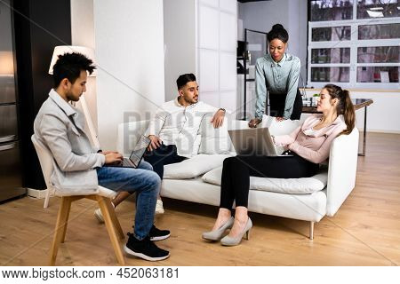 Young Diverse People Using Laptops In Coworking Space