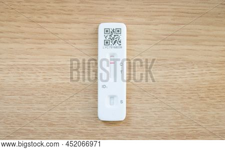 United Kingdom - March 26, 2022. Flat Lay Of Covid Lft Test Strip On A Wooden Desk With Copy Space. 