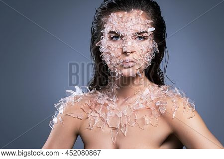 Female Face Covered With A Lot Small Pieces Of Glass Or Ice