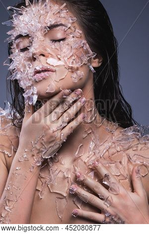 Female Face Covered With A Lot Small Pieces Of Glass Or Ice