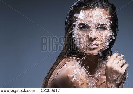 Female Face Covered With A Lot Small Pieces Of Glass Or Ice