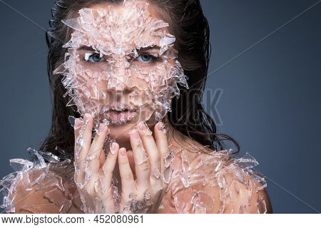 Female Face Covered With A Lot Small Pieces Of Glass Or Ice