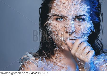 Female Face Covered With A Lot Small Pieces Of Glass Or Ice