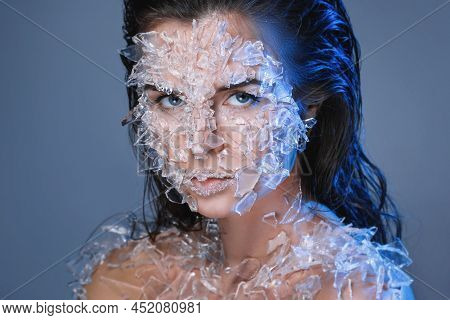 Female Face Covered With A Lot Small Pieces Of Glass Or Ice