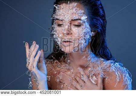 Female Face Covered With A Lot Small Pieces Of Glass Or Ice