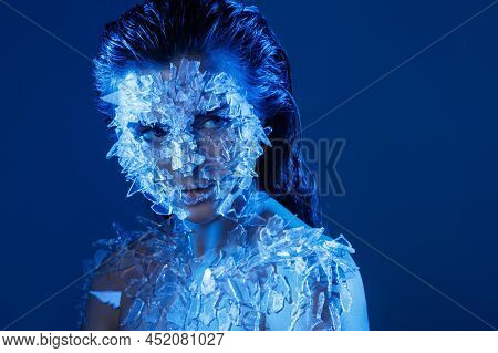 Female Face Covered With A Lot Small Pieces Of Glass Or Ice