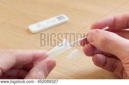 Man Holding Swab And Phial, Self-testing For Covid-19 With A Lateral Flow Test (lft), Uk