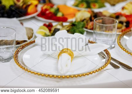 A Table With A Tablecloth, A Beautiful Serving Of White Dishes, A Beautiful Plate, Dinner In A Resta