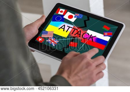 Ukrainian And Russian Flag On A Tablet And Inscription Attack.