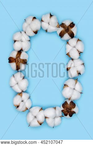 Number 0 Made Of Cotton Flowers And Isolated On Solid Blue Background. Floral Numeral Concept. One N