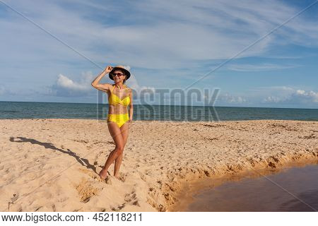 Fit Women In A Yellow Bikini At The Beach Known As Pitinga, In Arraial D\' Ajuda, Bahia, Brazil