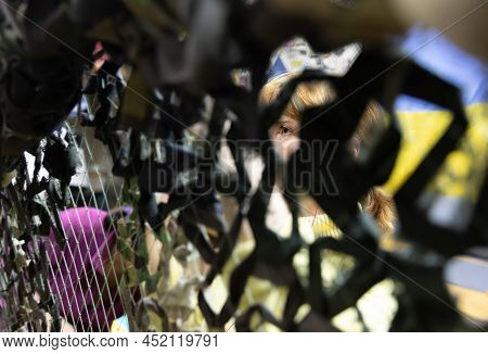 Kyiv, Ukraine - Apr. 01, 2022: A Group Of Volunteers In A Shelter Making Camouflage Net, From Differ