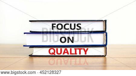 Focus On Quality Symbol. Concept Words Focus On Quality On Books On Beautiful Wooden Table White Bac