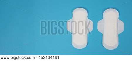 Woman Sanitary Napkins On Blue Background. Top View.