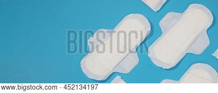 Woman Sanitary Napkins On Blue Background. Top View.